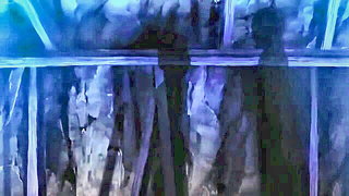 Couple mid-scene in a dim bedroom