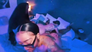 Couple on a made bed in an explicit scene