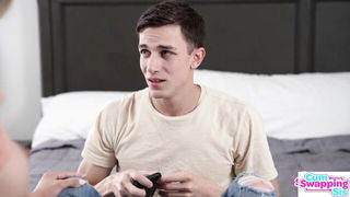 Couple on a made bed in an explicit scene
