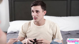 Couple on a made bed in an explicit scene