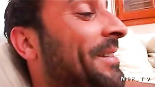 Explicit massage scene in a softly lit room