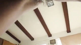 Couple on a made bed in an explicit scene