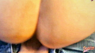 Couple on a made bed in an explicit scene