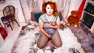 Couple on a made bed in an explicit scene