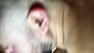 Solo performer with a toy on rumpled bedsheets