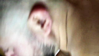 Solo performer with a toy on rumpled bedsheets