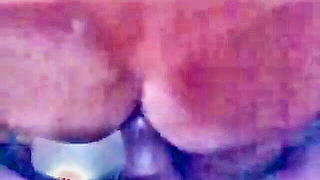 Couple on a patterned bedspread in an explicit scene