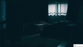 Couple mid-scene in a dim bedroom