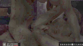 Solo performer with a toy on rumpled bedsheets