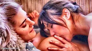 Couple on a patterned bedspread in an explicit scene