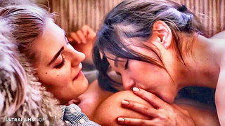 Couple on a patterned bedspread in an explicit scene