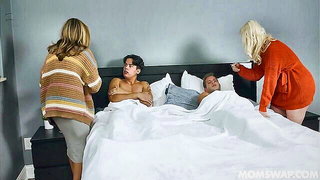 Explicit massage scene in a softly lit room