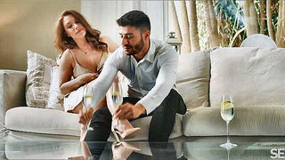 Couple on a made bed in an explicit scene