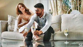 Couple on a made bed in an explicit scene