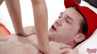 Solo performer with a toy on rumpled bedsheets