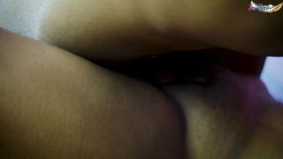 Amateur couple on a living room sofa in explicit scene
