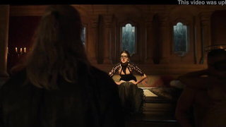 Studio set with performers in an explicit scene under bright lights