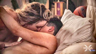 Amateur couple on a living room sofa in explicit scene