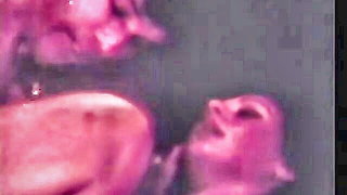 Explicit massage scene in a softly lit room