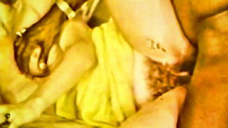 Amateur couple on a living room sofa in explicit scene