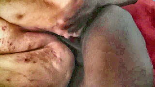 Couple mid-scene in a dim bedroom