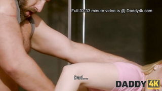 Couple on a made bed in an explicit scene