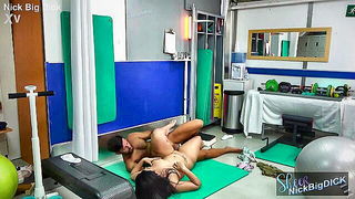 Couple on a patterned bedspread in an explicit scene