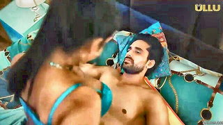 Couple on a patterned bedspread in an explicit scene