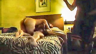 Amateur couple on a living room sofa in explicit scene