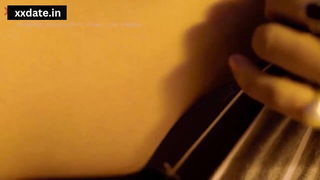 Explicit massage scene in a softly lit room