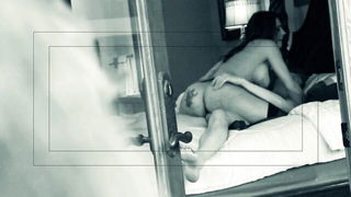 Explicit massage scene in a softly lit room