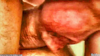 Amateur couple on a living room sofa in explicit scene