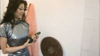 Solo performer with a toy on rumpled bedsheets