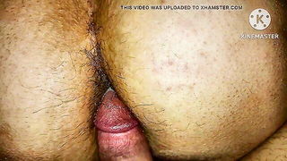 Couple on a made bed in an explicit scene