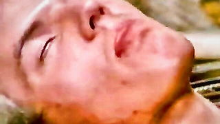 Explicit massage scene in a softly lit room