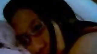 Couple on a made bed in an explicit scene