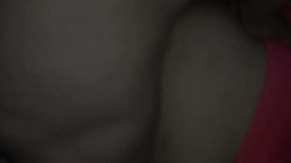 Couple on a made bed in an explicit scene