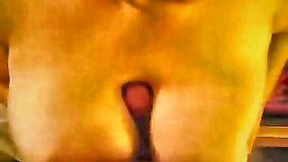 Explicit massage scene in a softly lit room