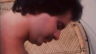 Explicit massage scene in a softly lit room