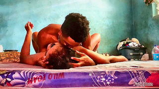 Couple on a patterned bedspread in an explicit scene