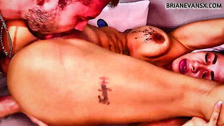 Couple on a made bed in an explicit scene