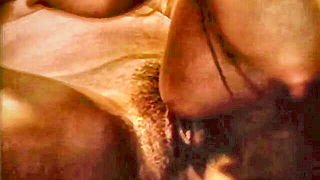Amateur couple on a living room sofa in explicit scene