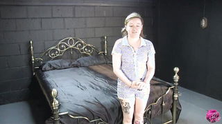 Couple on a made bed in an explicit scene