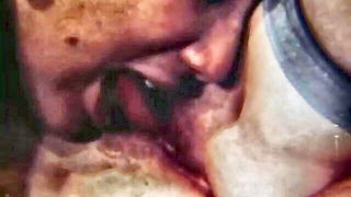 Amateur couple on a living room sofa in explicit scene