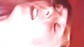 Solo performer with a toy on rumpled bedsheets