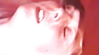 Solo performer with a toy on rumpled bedsheets