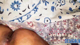 Couple on a patterned bedspread in an explicit scene