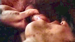 Explicit massage scene in a softly lit room