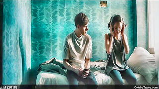 Couple mid-scene in a dim bedroom