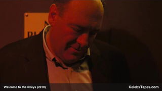 Couple mid-scene in a dim bedroom